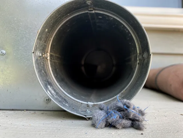 Wilton Dryer Vent Cleaning technician using specialized equipment to clear severe dryer vent blockage in Wilton